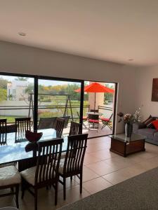 a living room with a table and chairs and a couch at Depa within Paraiso Country Club Golf Club in Emiliano Zapata