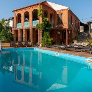 a large swimming pool in front of a building at Dimitris Cabin In surami in Surami