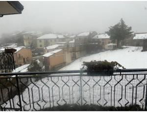 a view of a snow covered street from a balcony at Rose Irpinia Home in Montemarano