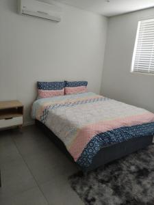 a bedroom with a bed and a night stand at Pebble Beach 204 in Sibaya
