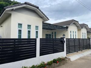 a fence in front of a house at Khwanlom House in Lampang