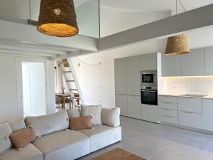 a living room with a couch and a kitchen at Casa Beliche in Aljezur