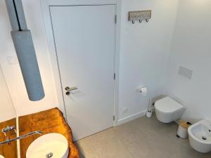 a bathroom with a toilet and a sink at Casa Beliche in Aljezur +4 photos