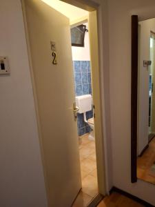 a bathroom with a door with the number on it at IN Kala in Rijeka
