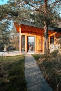 a log cabin with a walkway in front of it at Cocooon Wood, hébergement insolite Savoie in Saint-Paul-sur-Yenne
