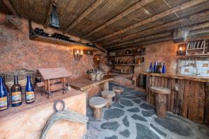 a painting of a bar in a room with stools at Apartamento con Vistas, Piscina y Tenis en El Hierro in Tigaday