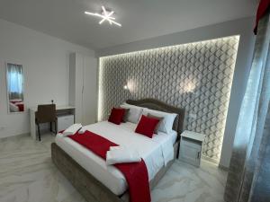 a bedroom with a large bed with red pillows at Safa Venice Station in Mestre +61 photos
