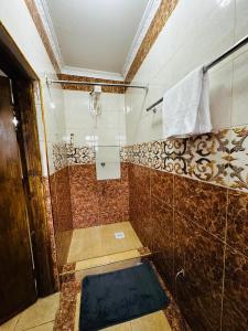 a bathroom with a shower with a glass wall at The Crib in Kitui +18 photos
