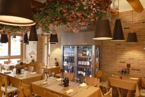 a dining room with tables and chairs and lights at LE RIVE Guest House La Ciosà in Chioggia +15 photos