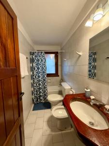a bathroom with a toilet and a sink at Nevada Hostel in San Carlos de Bariloche +51 photos