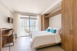 Ένα ή περισσότερα κρεβάτια σε δωμάτιο στο U-GO Edificio Ambar Roca en Rodadero Sur +26 φωτογραφίες