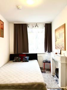 a bedroom with a bed and a large window at Welcome to Messe! Two-bedroom SmartApartment &Balcony in Hannover