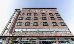 a tall brick building with a sign on it at Yeongjong Stay Hotel in Incheon