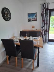 a dining room with a wooden table and chairs at Ferienwohnung Astrid in Melschede +6 photos