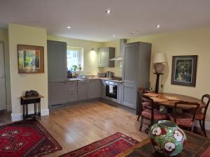 a kitchen with a table and a dining room at Writer's Retreat in Swanmore
