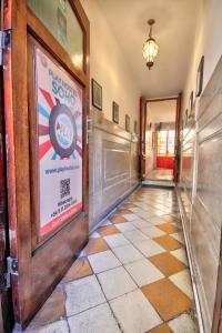 a hallway with a sign on the door of a building at Play Hostel Soho in Buenos Aires +45 photos