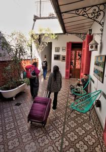 a group of people walking down a hallway with luggage at Play Hostel Soho in Buenos Aires