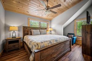 a bedroom with a bed and a ceiling fan at Rustic Retreat By Avada Properties in Greystone Heights