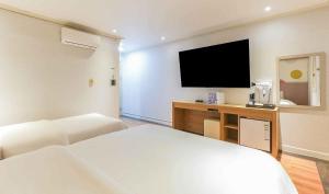 a hotel room with a bed and a flat screen tv at Yeongjong Stay Hotel in Incheon +32 photos
