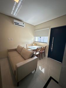 a living room with a couch and a table at Apartamento Prime 02 in Palmas