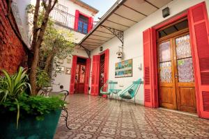 a courtyard with red doors and chairs in a building at Play Hostel Soho in Buenos Aires