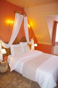 two beds in a bedroom with orange walls at Gite de La Lauzeraie in La Bourboule
