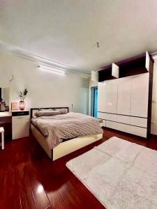 a bedroom with a large bed and a dresser at HnHome54AC in Hanoi +8 photos