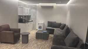 a living room with a couch and chairs and a kitchen at حياة العرب in Jeddah