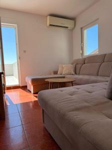 a living room with a couch and a table at Holiday Home Premium in Komarna
