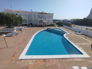 a swimming pool on the roof of a house at Apartamento 313 Castell Sol CB in Arenal d'en Castell
