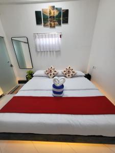 a bedroom with a large bed with a red and white blanket at Marino Bay Resort Kalametiya in Hambantota