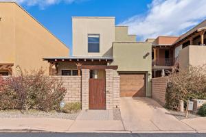 a house with a brown door on a street at Serene Retreat with Pool & Spa 3 Bed 3 Bath in Tucson
