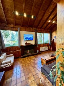 a living room with a couch and a fireplace at Nevada Hostel in San Carlos de Bariloche