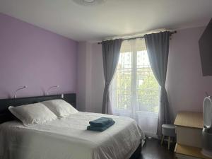 a bedroom with a bed and a large window at Livry Gargan in Livry-Gargan +34 photos