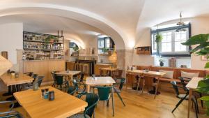 a restaurant with tables and chairs in a room at Martinhal Lisbon Chiado in Lisbon +17 photos