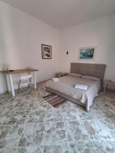 a bedroom with a bed and a table in it at Dimora AnVi in Bari