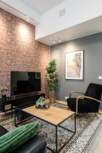 een woonkamer met een bakstenen muur bij City Home Alvari, ilmainen pysäköinti, free parking in Kuopio