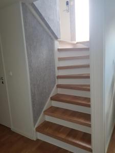 a staircase with wooden steps in a room at ossama in Åstorp +13 photos