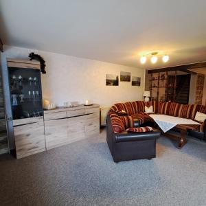 a living room with a couch and a table at Ferienhaus Luise in Sebnitz