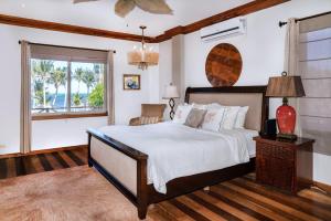 a bedroom with a large bed and a window at Oceans 23 in San Pedro Island +161 photos