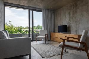 ein Wohnzimmer mit Sofa und Fernseher in der Unterkunft The 44, Fabulous villa for 19 guests in Playa del Carmen in Playa del Carmen