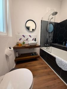a bathroom with a toilet and a sink at Il-Maxtura - Charming 17th Century House Of Character in the Historical Three Cities in Cospicua +39 photos