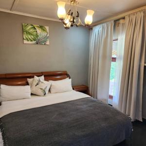 a bedroom with a large bed and a window at Mutanda Georgie's Bar & Grill in Mutanda