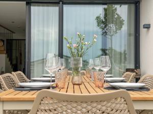 a wooden table with glasses and plates on it at Ava Lodge am Hainer See in Neukieritzsch