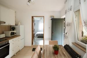 a kitchen and living room with a couch and a table at Panorama Lugasu in Lugaşu de Jos