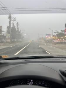 a view from a car windshield of a highway at Yna's Place - SMDC Tagaytay in Galicias
