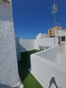 a shadow of a person on the roof of a building at Aparthaus Olive in Torrevieja