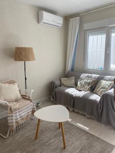 a living room with a couch and a table at Aparthaus Olive in Torrevieja