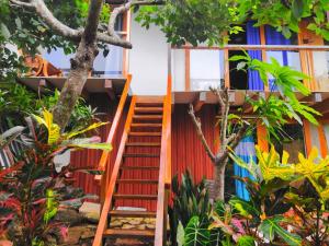 a staircase leading up to a house with trees at Mary House in San Cristobal