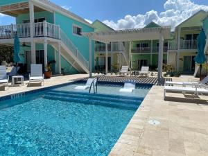 a swimming pool in front of a building with a house at The Turtle Nest at Cottages in Sand Bluff